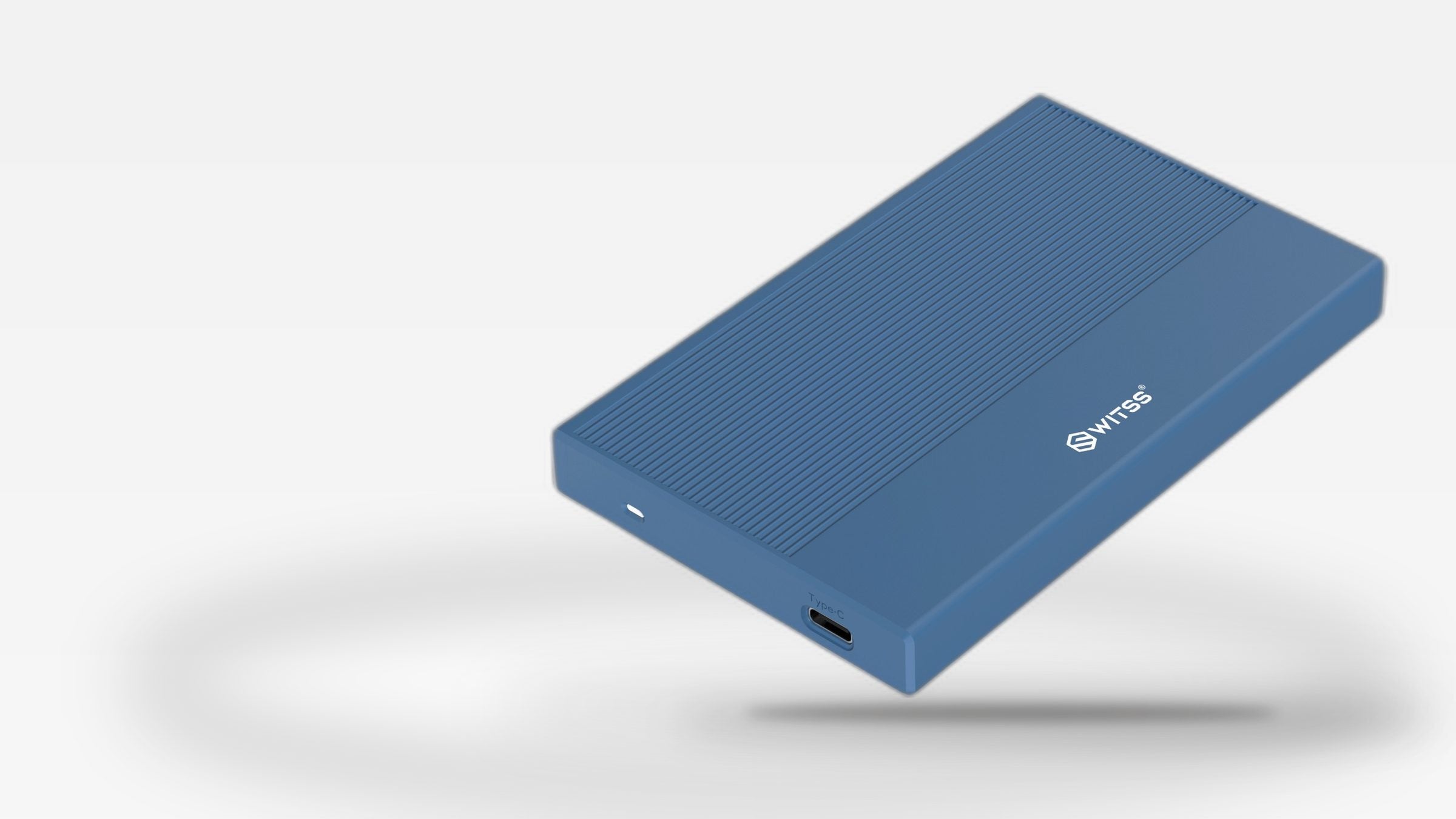 Open blue Switss® 2.5 inch enclosure with a 2.5 inch drive inside, on a warm desk