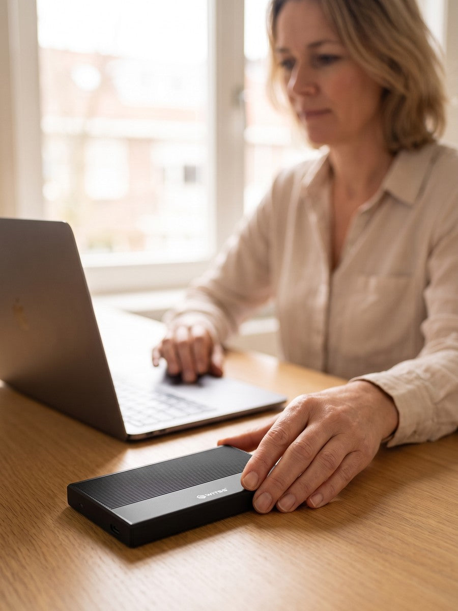 A woman places her hand on the enclosure next to the laptop